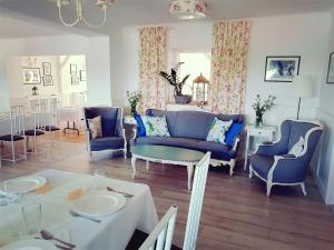 salon z niebieskimi krzesłami i stołem w obiekcie Folwark Leszczynówka w Srebrnej Górze
