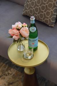 a bottle of beer and flowers on a table at Q8 Boutique Hotel in Portsmouth +24 photos
