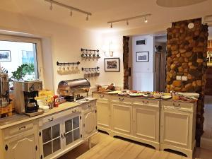 a kitchen with a counter with dishes on the counters at Folwark Leszczynówka in Srebrna Góra