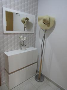 a hat and a mirror in a room at Apartments Roko in Kaštela