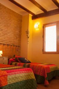 a bedroom with two beds and a window at Homely Nest Valencia El Carme in Valencia