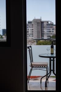 einen Tisch und Stuhl mit einer Flasche Wein auf dem Balkon in der Unterkunft Koi Town Heart in Budva