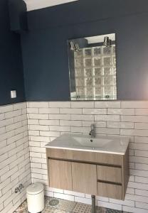 a bathroom with a sink and a mirror at Casa Lilia in Monchique