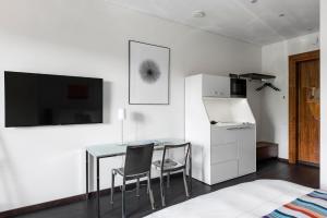 a white room with a table and two chairs at The Joseph in Vilnius +69 photos