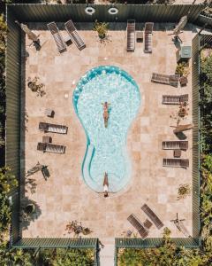 an aerial view of a swimming pool with a person in a light bulb at Kahari Resort, a Peace and Plenty Resort Property in Georgetown