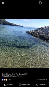 een foto van een strand met water bij B&b Slow life in Marina di Camerota