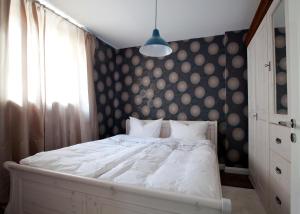Schlafzimmer mit einem Bett mit einer Polka-Punkt-Wand in der Unterkunft Ellena`s FEWO am Uke in Hamburg
