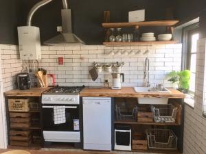 a kitchen with a black and white stove top oven at Casa Sofia in Monchique