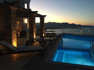 a resort pool with a view of the water at Endless View Villa in Agios Nikolaos