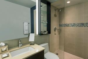 a bathroom with a toilet and a sink and a shower at Hotel Hayden New York in New York