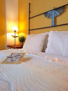 a large white bed with a cross on top of it at Helicon Muses Friendly Mountain B&B Guesthouse in Evangelístria