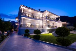a large white building with a pathway in front of it at Studios Filipidis in Chrysi Ammoudia