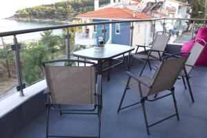 a table and chairs on a balcony with a view at Blue4Aqua Apartments in Kavála