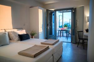 a bedroom with a large bed with two towels on it at Melidron Hotel Suites Villas in Agios Prokopios +291 photos