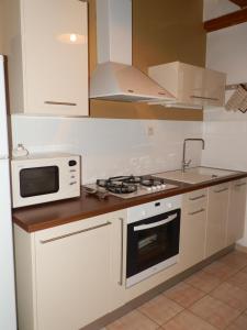 a kitchen with a microwave and a stove top oven at gite des ferrieres in La Ville-ès-Nonais