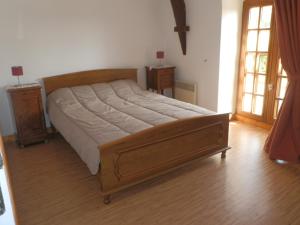 a bedroom with a bed and two tables and windows at gite des ferrieres in La Ville-ès-Nonais