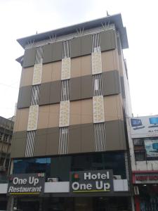 a hotel one up building in a city at Hotel One Up in Ahmedabad