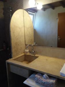 a bathroom with a sink and a mirror at CHRYSTALL'S COTTAGE in Lagonissi