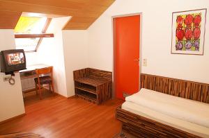 a room with a bed and a tv in it at Fränkischer Gasthof Lutz in Giebelstadt