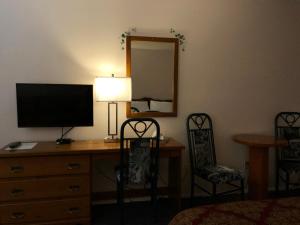 a bedroom with a dresser and a chair at Chase Country Inn in Chase