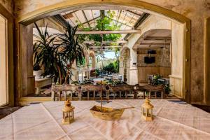 a room with a table and chairs in a building at Mali Miločer Bay Accommodation in Sveti Stefan