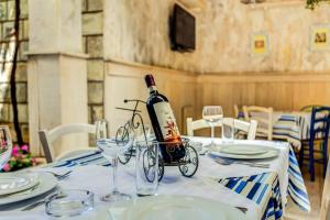 a bottle of wine sitting on a table with glasses at Mali Miločer Bay Accommodation in Sveti Stefan