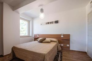 a bedroom with a bed and a window at B&B Madonna Carradori Country in Offagna +30 photos