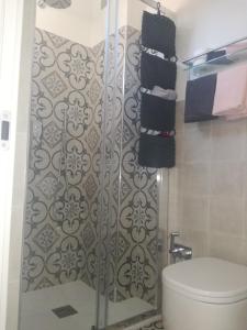 a bathroom with a shower with a toilet and towels at Rivamare San Terenzo in Lerici