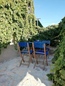 twee blauwe stoelen naast een tafel bij Blue Holidays Apartment in Šibenik