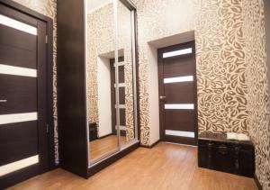 a room with two mirrors and a hallway with wooden floors at Апартаменты в центре на Ришельевской in Odesa