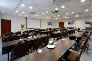 a conference room with tables and chairs and a whiteboard at Casa Andina Select Moquegua in Moquegua +35 photos