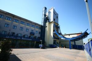 a building with a car parked in front of it at Blu Hotel - Sure Hotel Collection by Best Western in Collegno