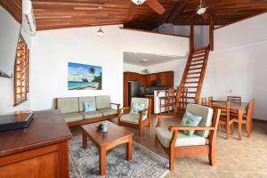 a living room with a couch and chairs and a table at Orchid Bay Resort in Corozal