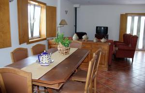 a dining room with a wooden table and chairs at 'Casa do Afonso' in Esposende