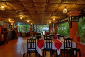 a dining room with tables and chairs in a restaurant at Sonalong Boutique Village & Resort in Siem Reap