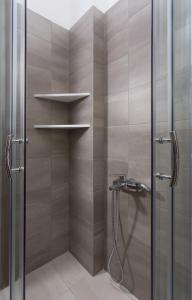 a shower in a bathroom with a glass door at Venetia Apartments in Monemvasia