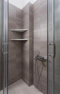 a shower in a bathroom with a glass door at Venetia Apartments in Monemvasia +30 photos