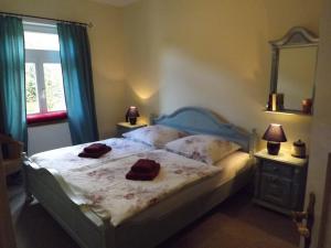 a bedroom with a bed with two towels on it at Landhaus Lautenthal in Lautenthal