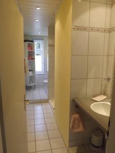 a bathroom with a sink and a mirror at Landhaus Lautenthal in Lautenthal +53 photos