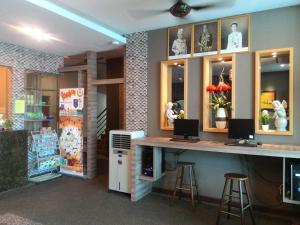 a bar in a store with two stools and a counter at JQ Suria 18 Hotel in Ipoh