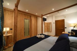 Rúm í herbergi á Hotel Pangrazzi - 3 stelle superior