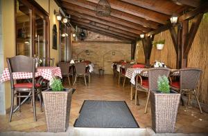 a restaurant with tables and chairs in a room at Pension Yellow in Timişoara