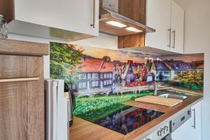 a kitchen with a painting on the wall at Haus der Kaiser in Goslar