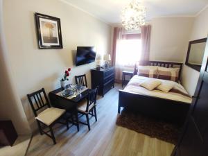 Postel nebo postele na pokoji v ubytování Apartamenty Aleksandria