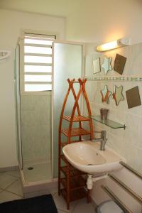 a bathroom with a sink and a shower at Villa with swimming pool close to the beach MQSL11 in Sainte-Luce