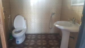a bathroom with a toilet and a sink at Mohéli Vanilla Lodge in Nioumachoua +63 photos