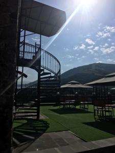 a view of a patio with benches and the sun at Nairi Hotel in Jermuk