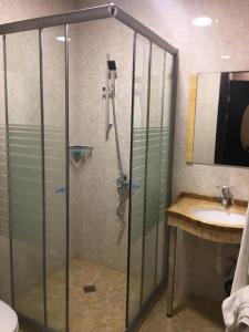 a bathroom with a shower and a sink at Nairi Hotel in Jermuk