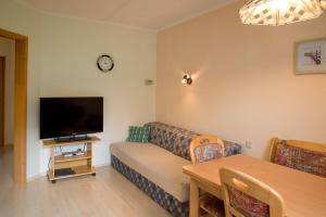 a living room with a couch and a flat screen tv at Ferienwohnung Märzinger in Ulrichsberg