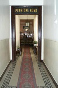 a hallway with a red carpet in a building at Pension Roma in Cairo